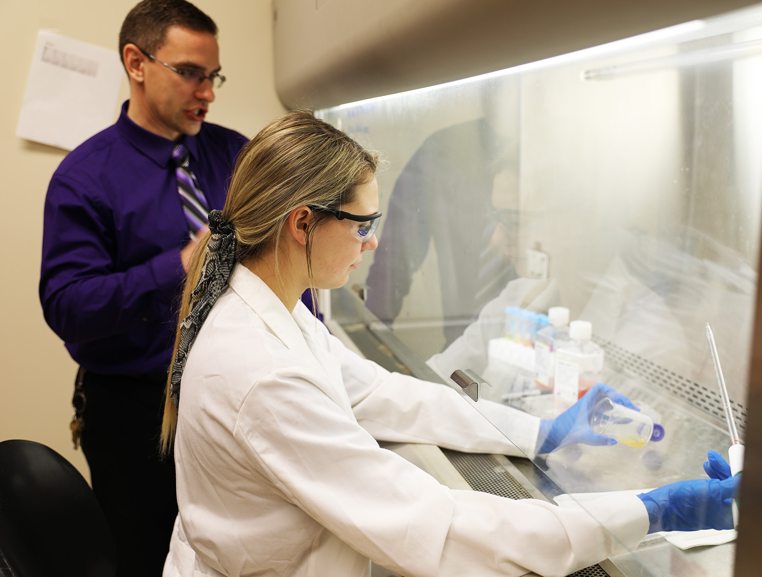 student with professor in lab